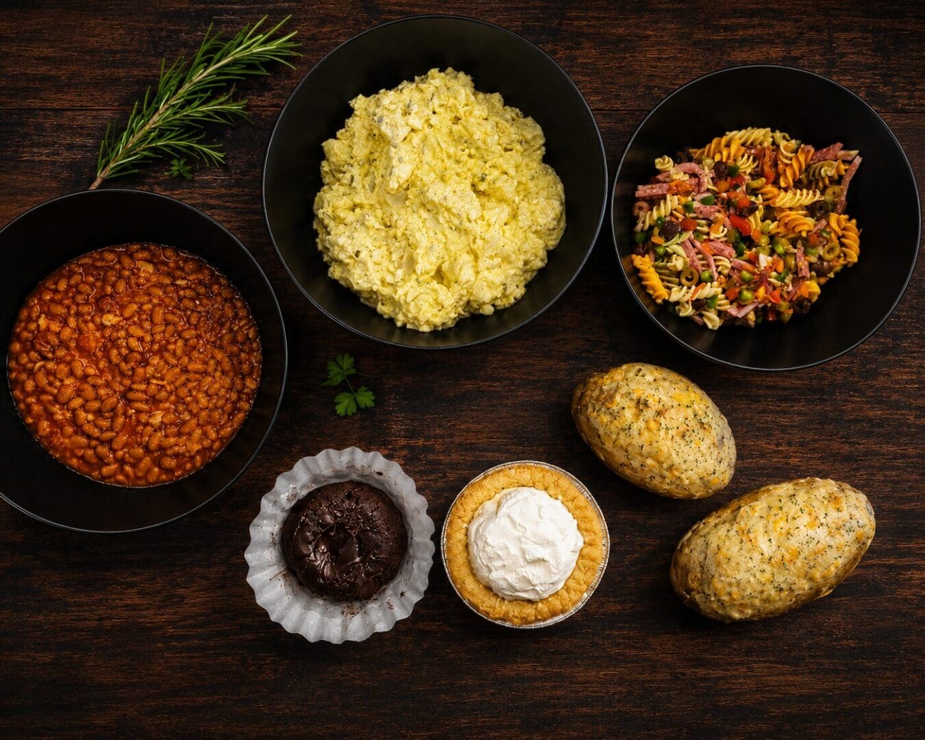 Bowls of beans, salads, baked potatoes, desserts